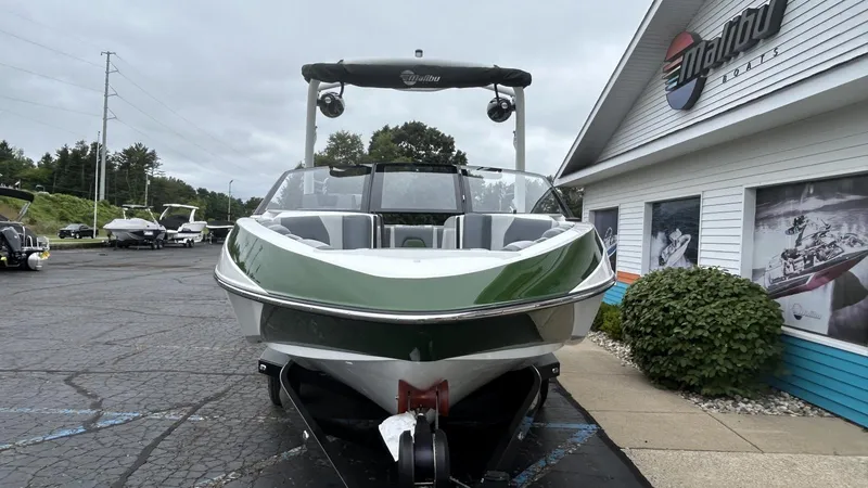 Slide: The Image of 2021 Malibu Wakesetter 21 VLX boat displayed outside dealership. - 5