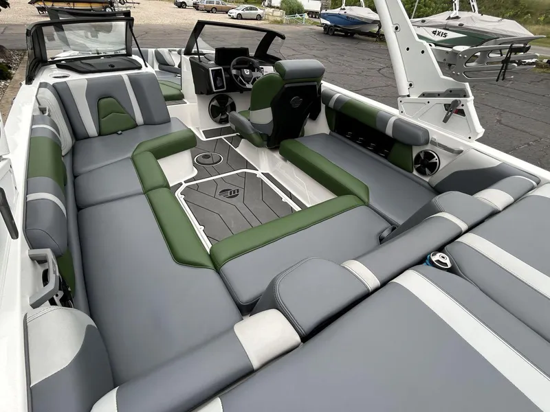 Slide: The Image of 2021 Malibu Wakesetter 21 VLX interior with gray and green seating, modern dashboard, and spacious layout. - 8