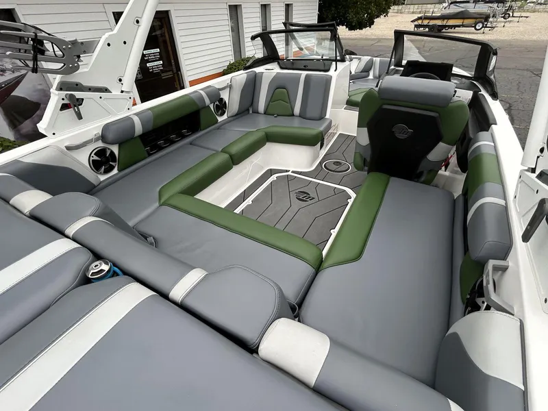 Slide: The Image of Interior of 2021 Malibu Wakesetter 21 VLX boat with gray and green seating. - 9