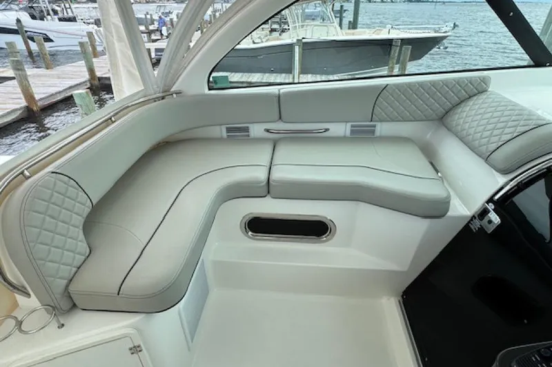 Slide: The Image of 2022 Pursuit OS 385 Offshore boat interior with cushioned seating and elegant design. - 10