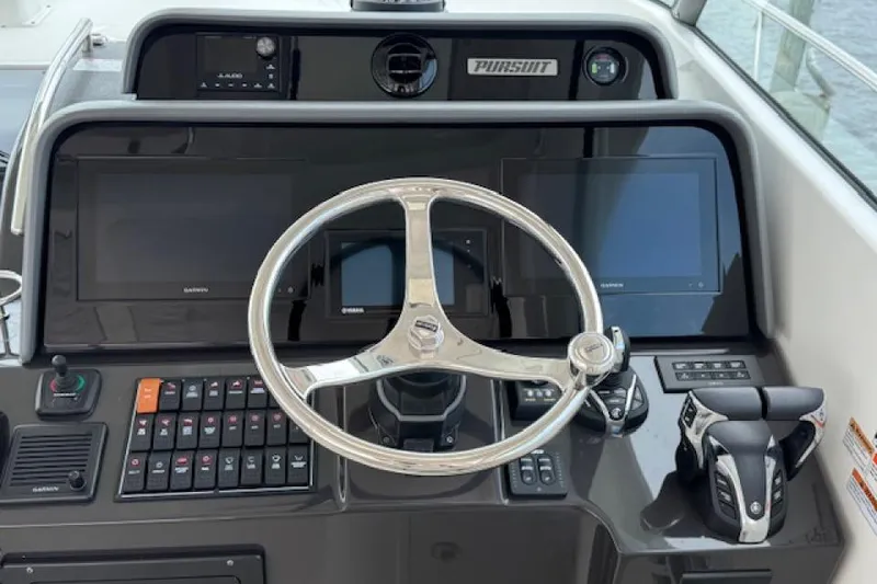 Slide: The Image of Helm of 2022 Pursuit OS 385 Offshore boat with modern controls and displays. - 12