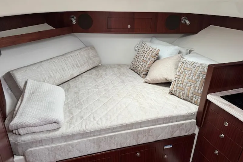 Slide: The Image of Luxurious cabin interior of 2022 Pursuit OS 385 Offshore boat with cozy bedding. - 20