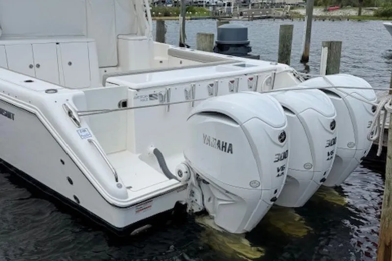 Slide: The Image of 2022 Pursuit OS 385 Offshore boat with triple Yamaha outboard engines docked. - 5