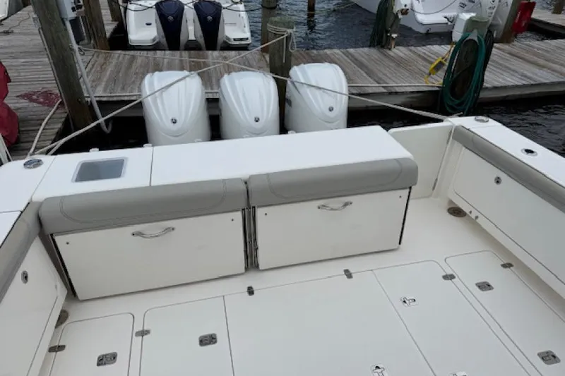 Slide: The Image of 2022 Pursuit OS 385 Offshore boat with triple outboard engines at dock. - 6