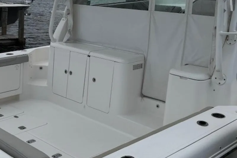 Slide: The Image of 2022 Pursuit OS 385 Offshore boat interior with storage compartments and seating. - 7