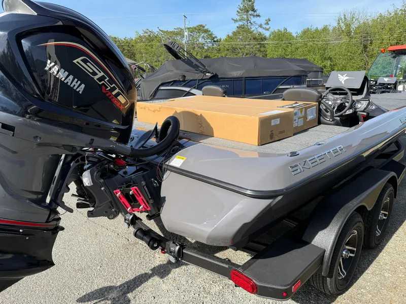 Slide: The Image of 2025 Skeeter ZXR21 boat with Yamaha engine, parked on trailer, outdoors. - 13