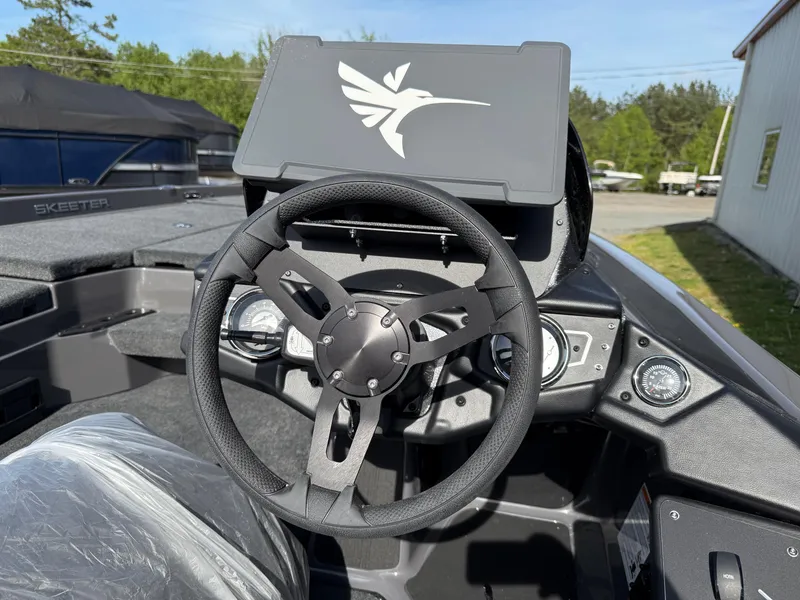 Slide: The Image of 2025 Skeeter ZXR21 boat dashboard with steering wheel and control panel. - 16
