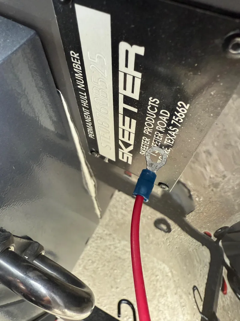 Slide: The Image of Close-up of a 2025 Skeeter ZXR21 hull identification plate with wiring. - 21