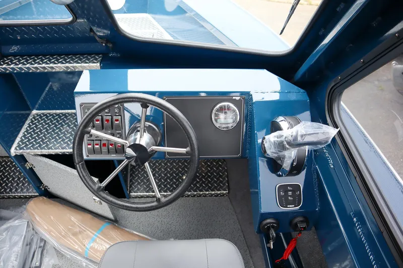 Slide: The Image of 2025 Hewescraft 240 Ocean Pro ET HT boat dashboard with steering wheel and controls. - 15