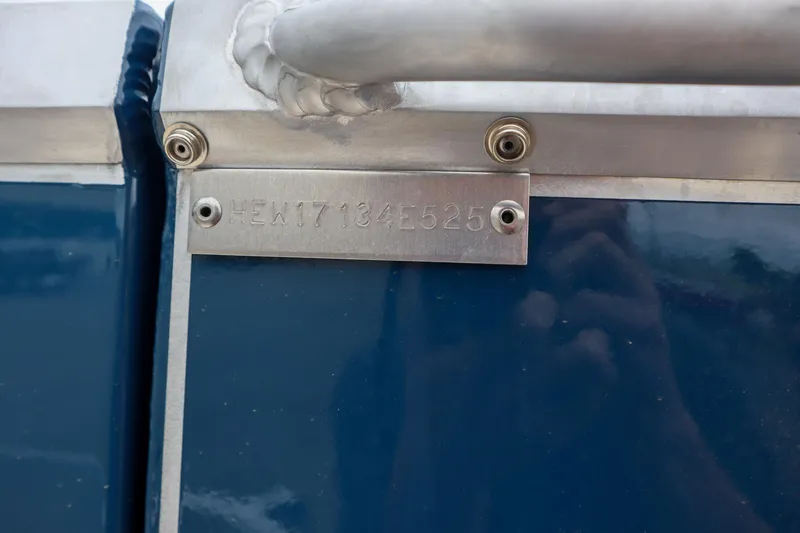 Slide: The Image of 2025 Hewescraft 240 Ocean Pro ET HT boat identification plate on blue hull. - 17