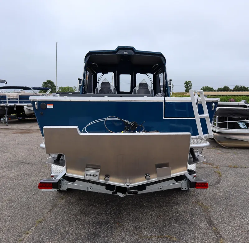 Slide: The Image of 2025 Hewescraft 240 Ocean Pro ET HT boat, rear view, parked on pavement. - 3