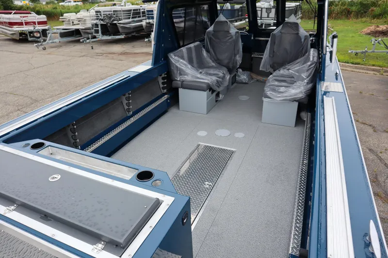 Slide: The Image of 2025 Hewescraft 240 Ocean Pro ET HT boat interior with covered seats and spacious deck. - 4