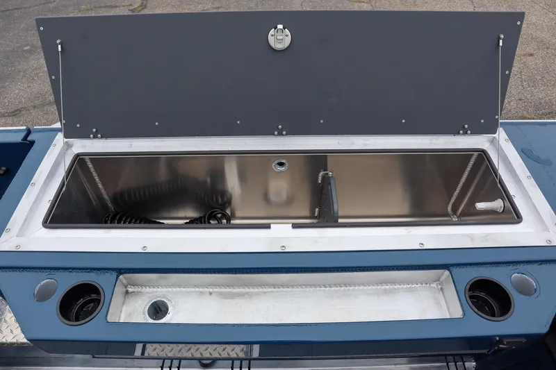 Slide: The Image of 2025 Hewescraft 240 Ocean Pro ET HT boat storage compartment, open lid, stainless steel interior. - 6
