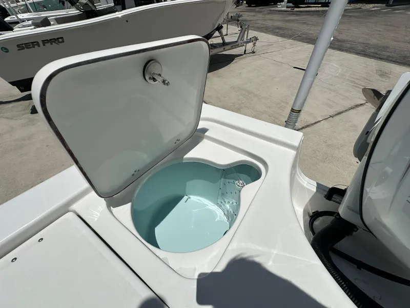 Slide: The Image of 2026 Sea Pro 230 Bay boat livewell with open lid, showcasing interior design. - 16