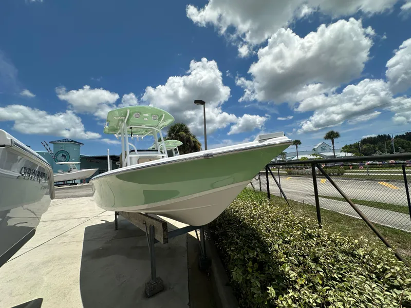 Slide: The Image of 2026 Sea Pro 230 Bay boat displayed outdoors under a partly cloudy sky. - 3