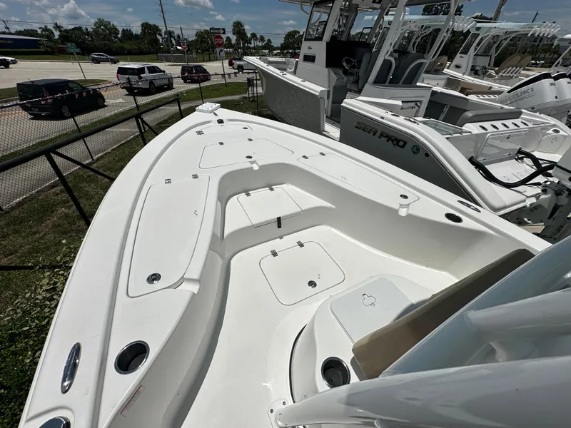 Slide: The Image of 2026 Sea Pro 230 Bay boat deck, featuring spacious seating and storage compartments. - 5