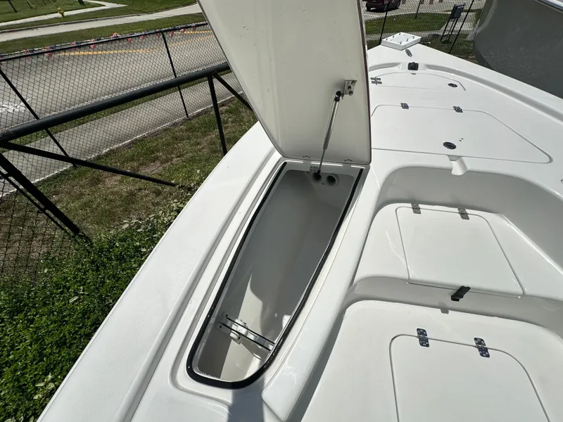Slide: The Image of 2026 Sea Pro 230 Bay boat storage compartment open, showcasing spacious interior design. - 6