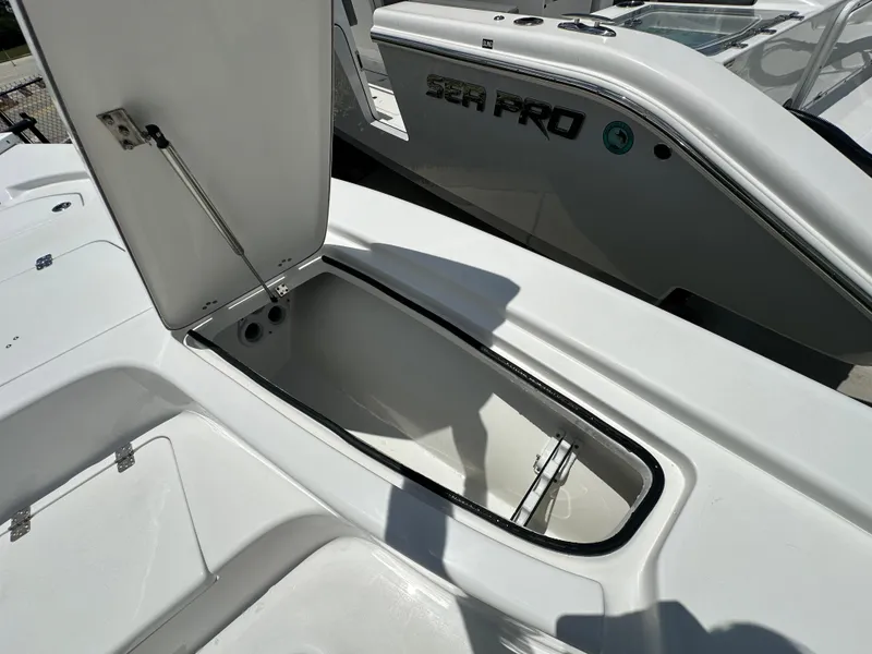 Slide: The Image of 2026 Sea Pro 230 Bay boat with open storage compartment, showcasing sleek design and functionality. - 9