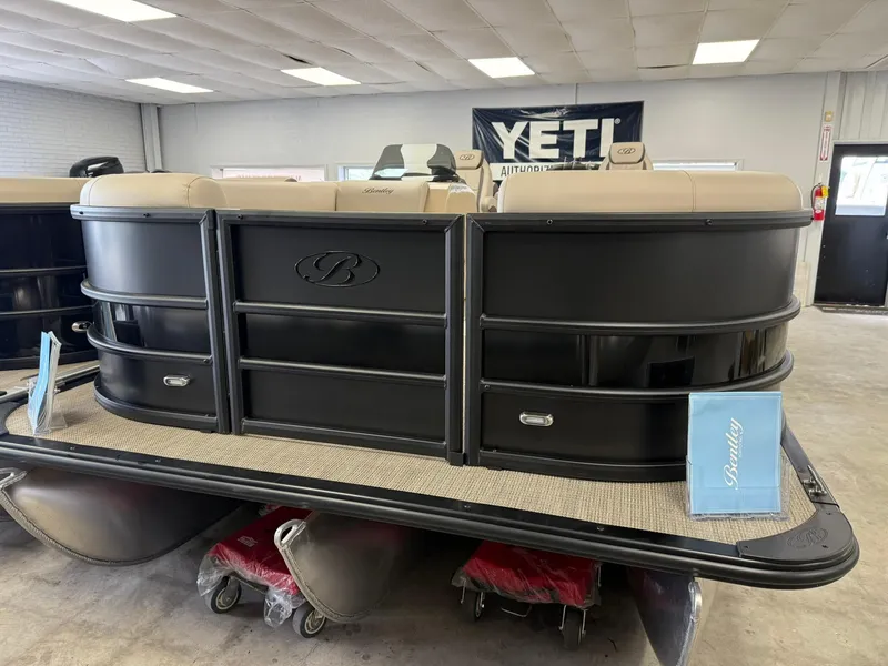 Slide: The Image of 2026 Bentley Pontoons Legacy 243 Navigator, black exterior, displayed indoors. - 1