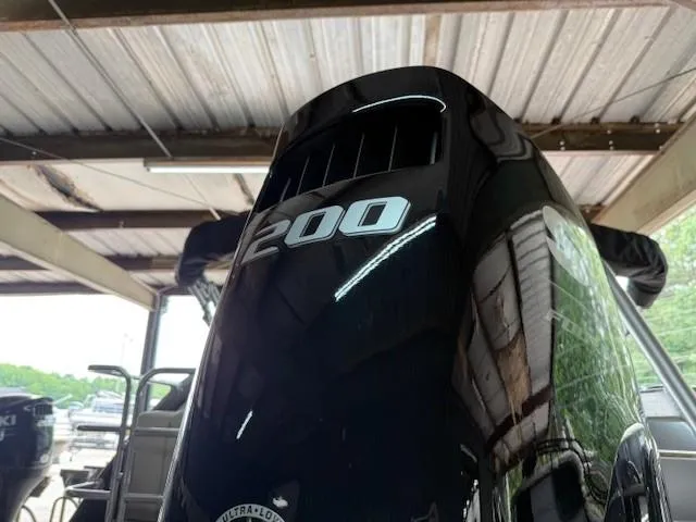 Slide: The Image of 2026 Bentley Pontoons Legacy 243 Navigator with 200 HP engine in a covered dock. - 10