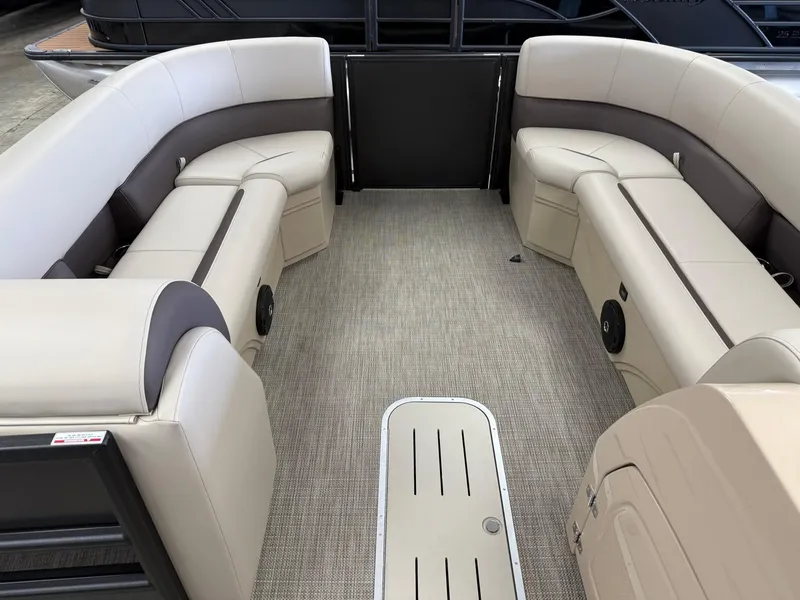 Slide: The Image of 2026 Bentley Pontoons Legacy 243 Navigator interior with beige seating and carpeted floor. - 2