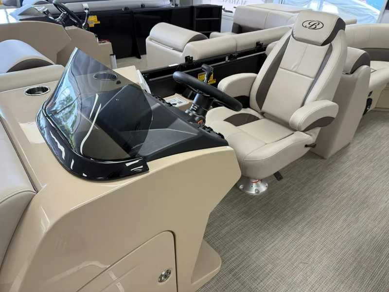Slide: The Image of 2026 Bentley Pontoons Legacy 243 Navigator interior with luxurious captain's chair and sleek dashboard. - 5