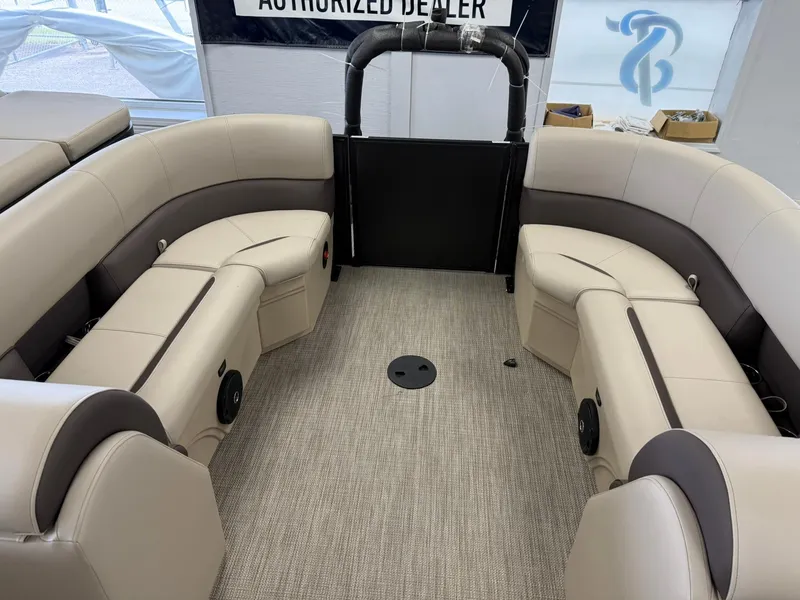 Slide: The Image of 2026 Bentley Pontoons Legacy 243 Navigator interior with beige seating and carpeted floor. - 8