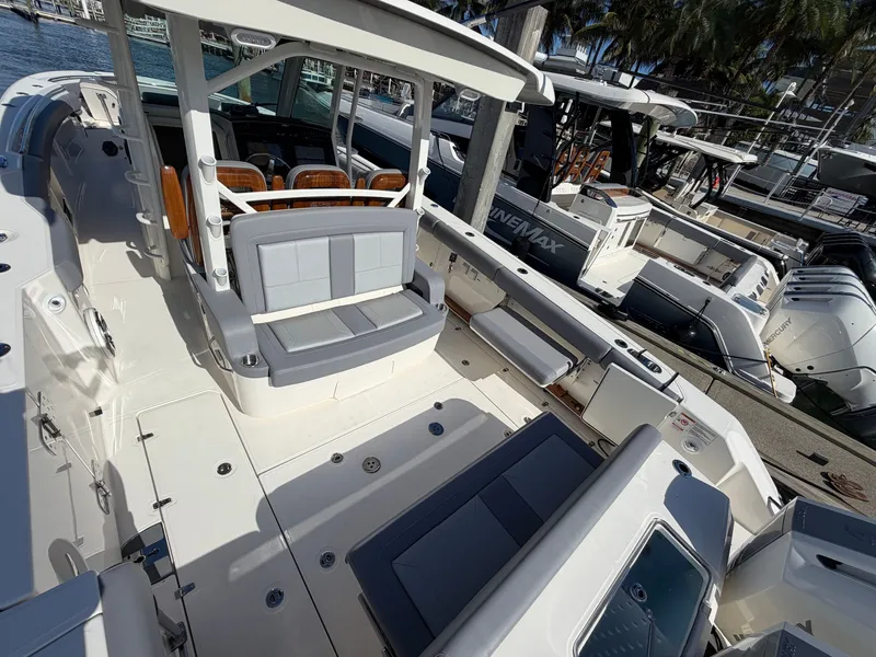 Slide: The Image of Boston Whaler 380 Outrage 2026: Spacious deck with seating, lounging areas, and modern amenities. - 26