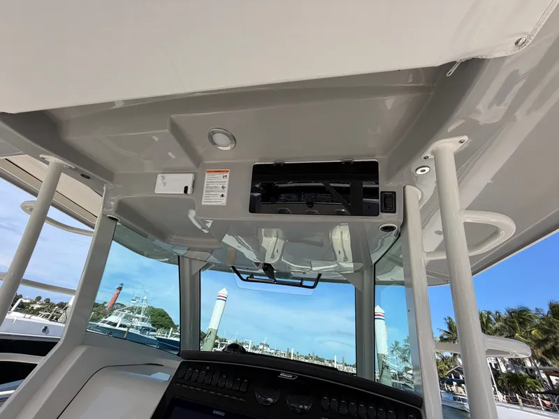 Slide: The Image of The image shows the cockpit of a Boston Whaler 380 Outrage with modern electronics and a clear sky. - 30