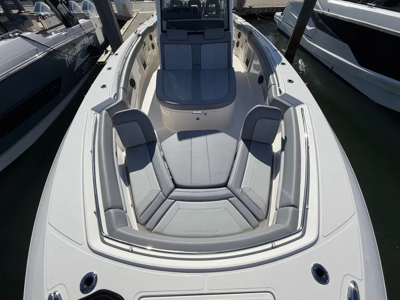 Slide: The Image of The image shows the deck of a 2026 Boston Whaler 380 Outrage with gray upholstery. - 15