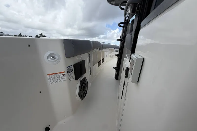 Slide: The Image of Side view of a Boston Whaler 380 Outrage with speaker and gray cushions. - 26