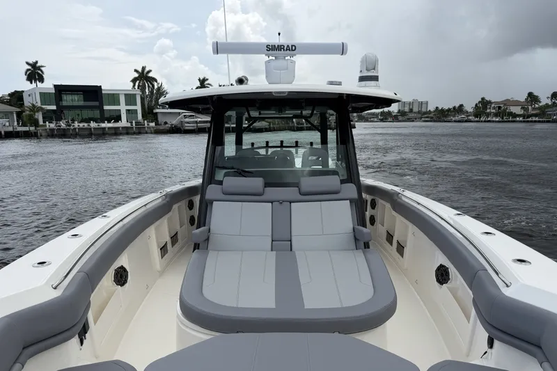 Slide: The Image of The image shows the deck of a 2027 Boston Whaler 380 Outrage with gray upholstery. - 37