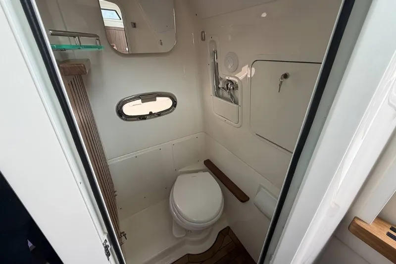Slide: The Image of The cabin of a 2027 Boston Whaler 380 Outrage features a compact toilet with modern design. - 43
