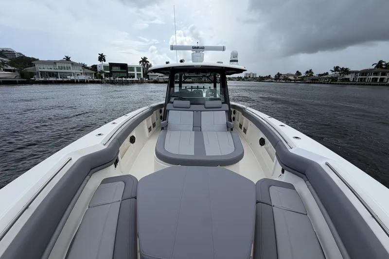 Slide: The Image of The image shows the deck of a 2027 Boston Whaler 380 Outrage with gray upholstery. - 36