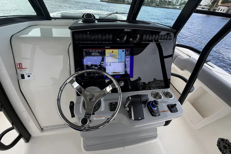 Slide: The Image of The cockpit of the 2027 Boston Whaler 380 Outrage features a modern helm with a large display. - 30