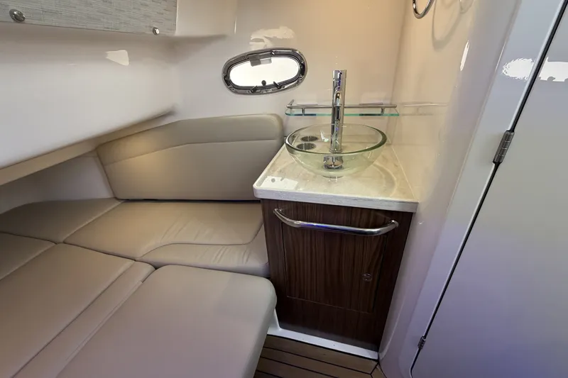 Slide: The Image of Interior of a modern cabin with leather seating, glass sink, and wooden cabinetry. - 42