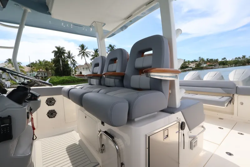 Slide: The Image of Boston Whaler 380 Outrage 2027: Luxurious seating with armrests, surrounded by palm trees and water. - 33