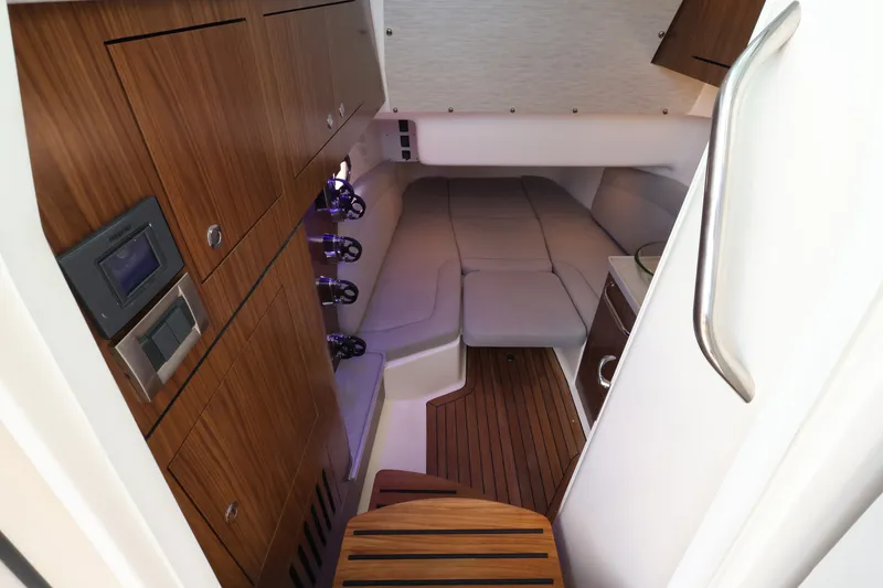 Slide: The Image of Interior of the 2027 Boston Whaler 380 Outrage with wood flooring and cushioned seating areas. - 41