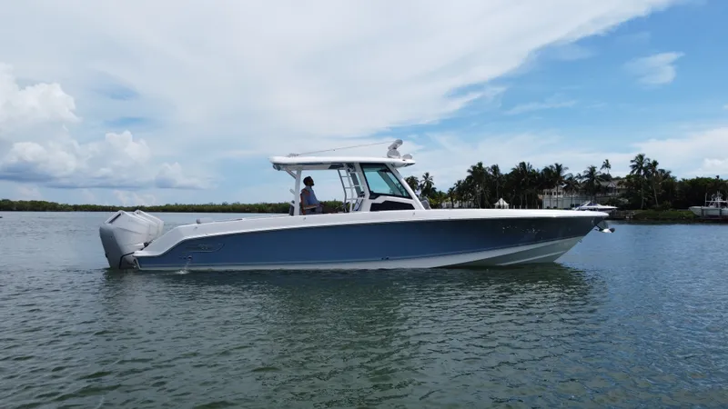 Slide: The Image of Boston Whaler 380 Outrage from 2027 on calm water with a blue sky in the background. - 4