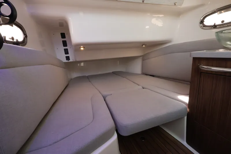 Slide: The Image of Interior of the 2027 Boston Whaler 380 Outrage with gray cushions and wooden flooring. - 44