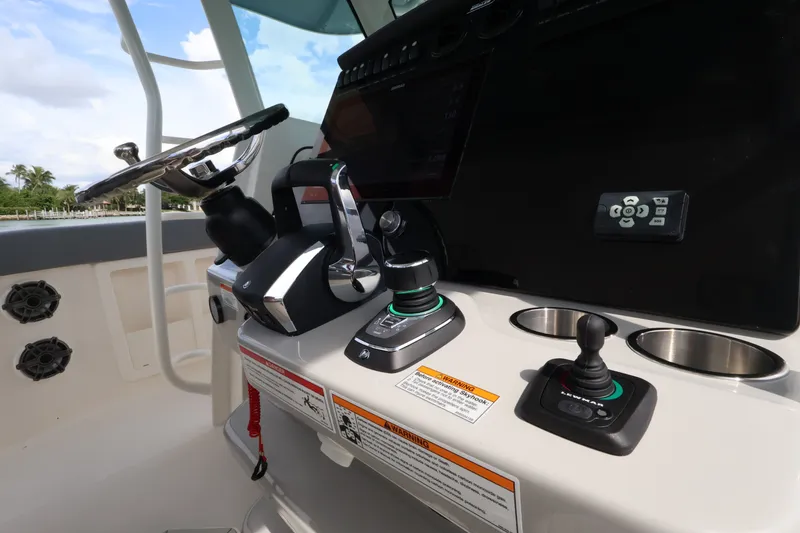 Slide: The Image of The image shows the helm of a Boston Whaler 380 Outrage with modern controls. - 37
