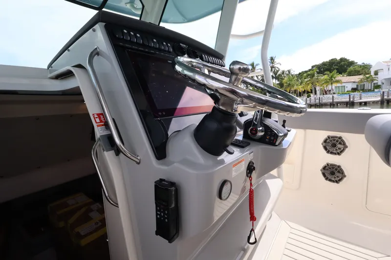 Slide: The Image of Helm of the Boston Whaler 380 Outrage with modern steering wheel and electronics. - 38
