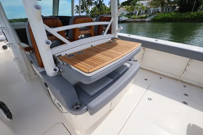 Slide: The Image of The image shows the deck of a 2027 Boston Whaler 380 Outrage with sleek wooden features. - 30