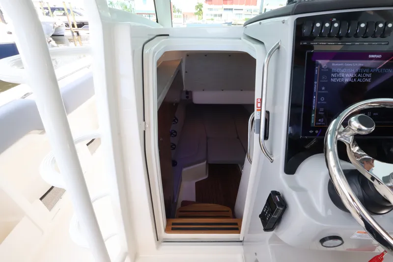 Slide: The Image of Cabin access of the 2027 Boston Whaler 380 Outrage with modern controls and comfortable seating. - 40