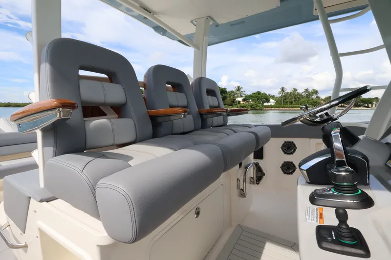 Slide: The Image of The image shows the cockpit of a 2027 Boston Whaler 380 Outrage with gray seats and modern controls. - 32