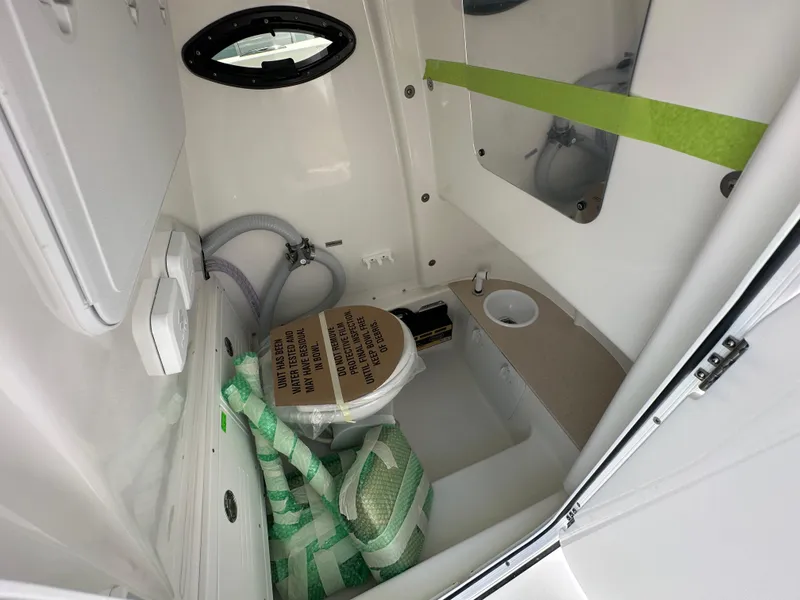Slide: The Image of Interior of 2026 Sea Pro 262 Center Console boat bathroom with sink and storage. - 10