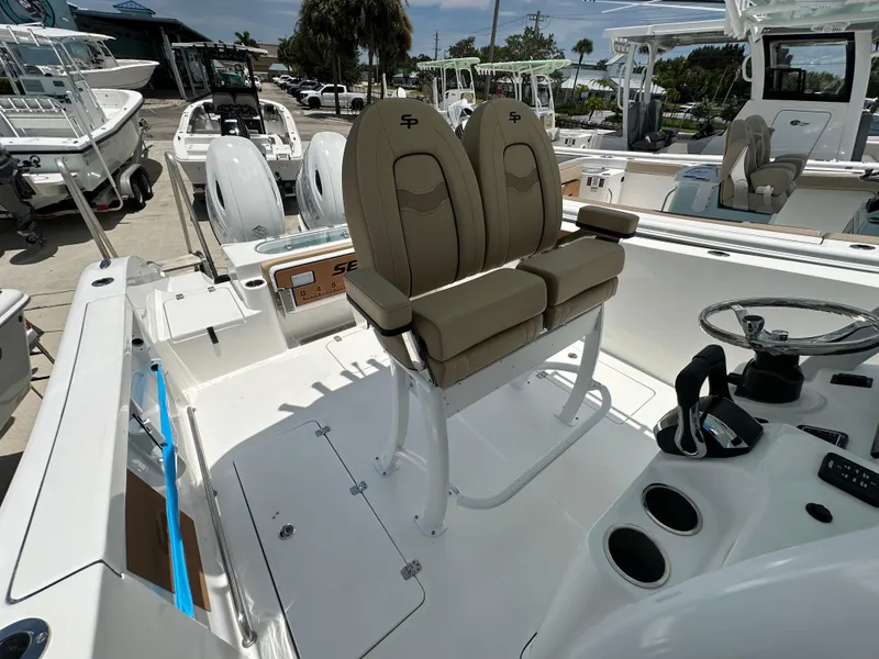 Slide: The Image of 2026 Sea Pro 262 Center Console boat interior with dual seats and steering wheel. - 11