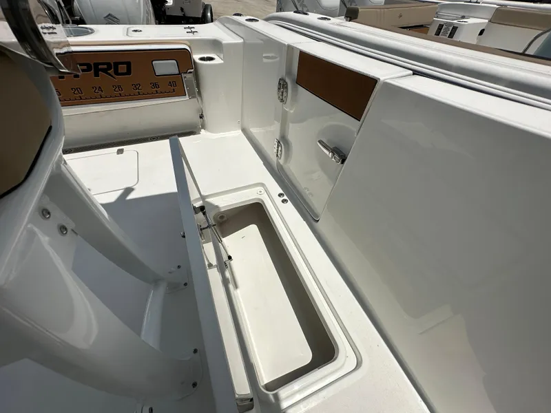 Slide: The Image of 2026 Sea Pro 262 Center Console interior with open storage compartment and sleek design. - 12
