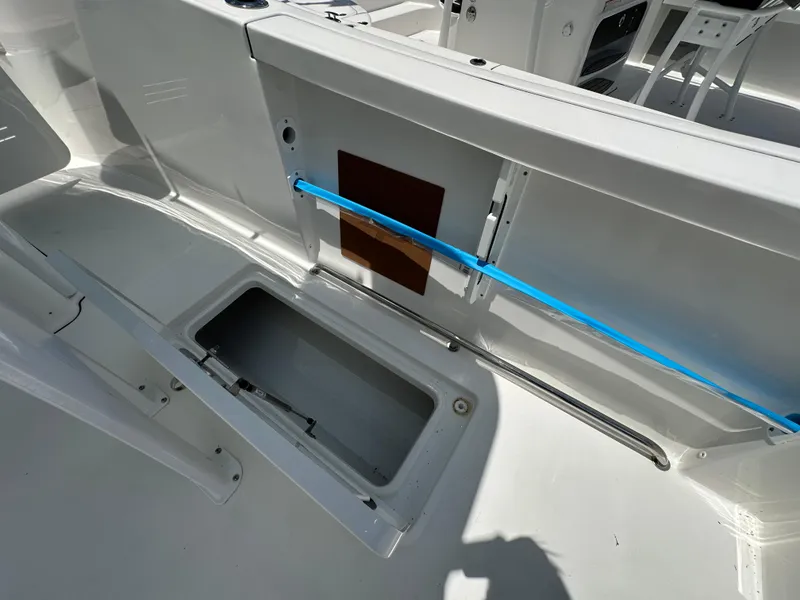 Slide: The Image of 2026 Sea Pro 262 Center Console boat interior with open storage compartment. - 13