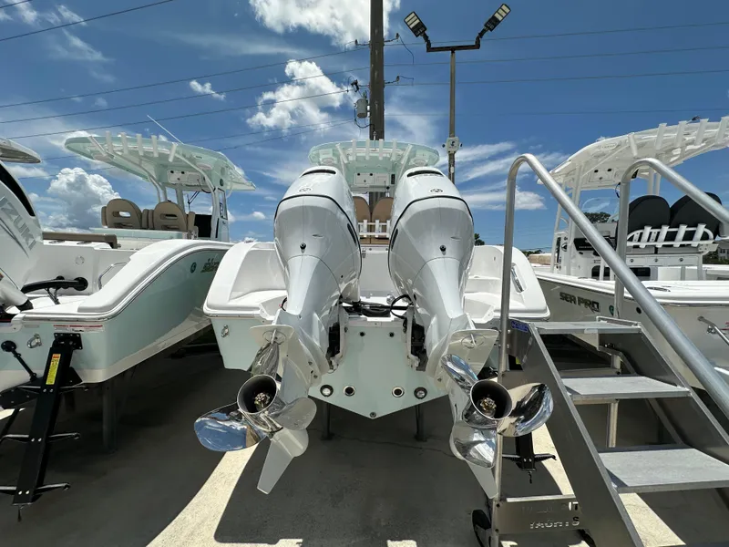 Slide: The Image of 2026 Sea Pro 262 Center Console boat with dual outboard engines displayed outdoors. - 3